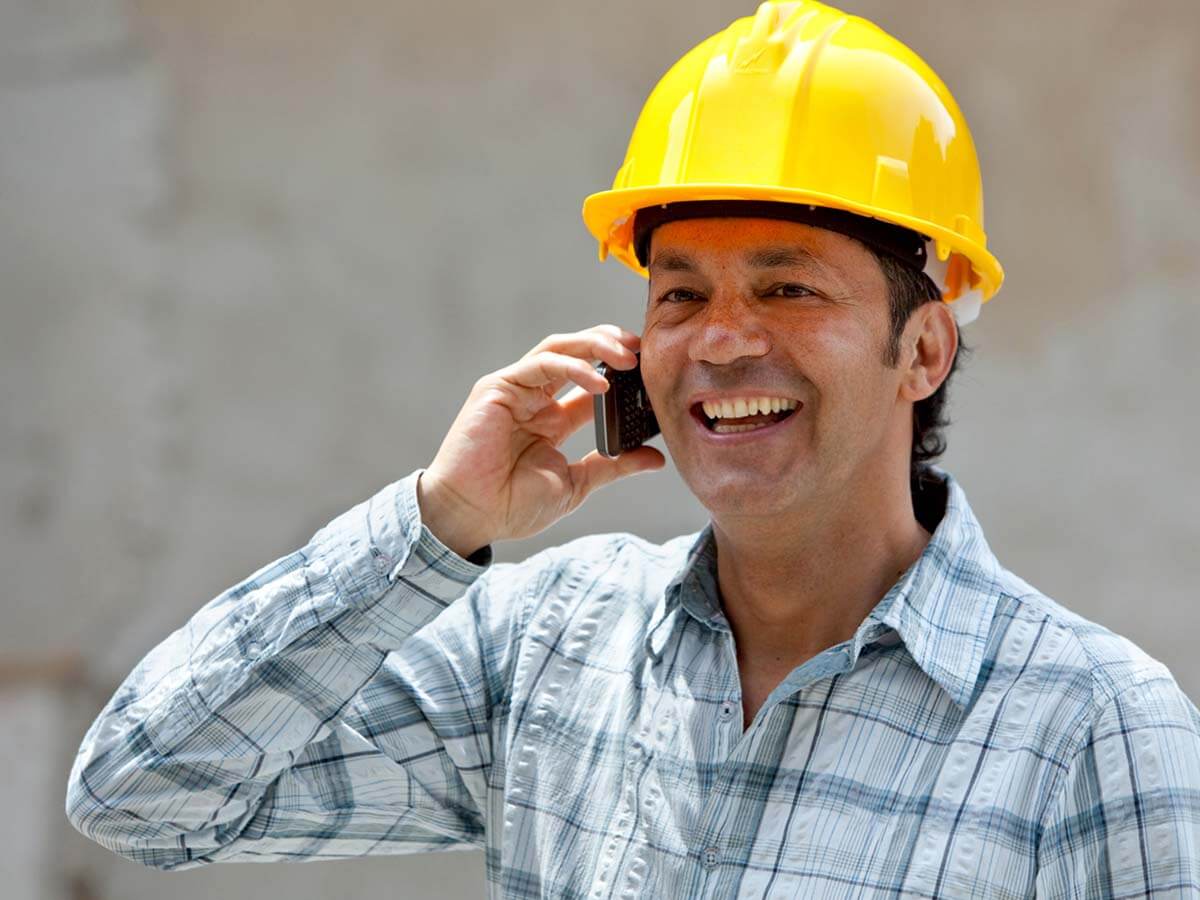 Roofing contractor talking on the phone.